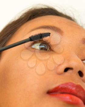 Girl Applying Mascara On Her Eyelashes Using Cosmetics