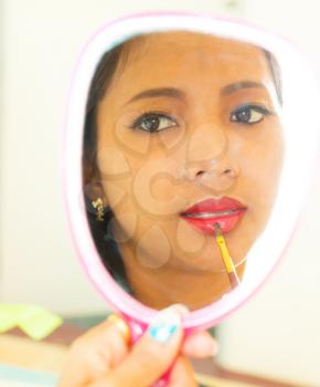 Applying Lip Gloss In Mirror Showing Beauty