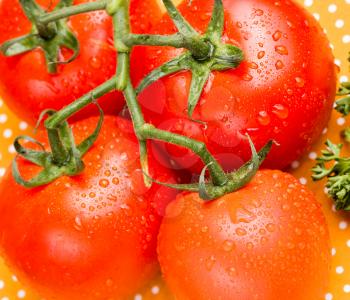 Overhead close up of juicy red vine tomatoes on a table top