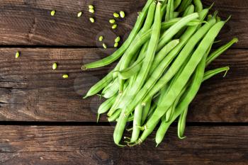 Fresh green beans on dark wooden rustic background top view copy space flat lay