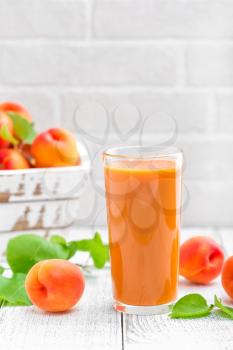 Apricot juice and fresh fruits with leaves
