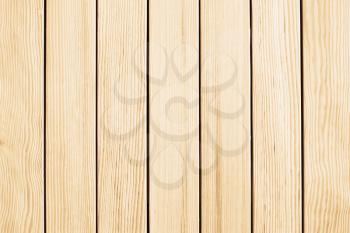 Beige wooden background.Vertical white fence