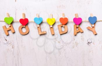 the word holiday from the wooden letters on a white background old