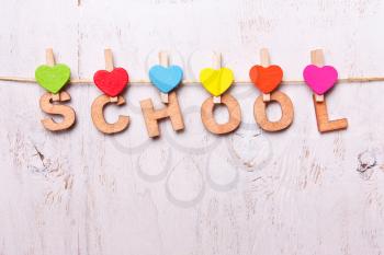 the word school from the wooden letters on a white background old