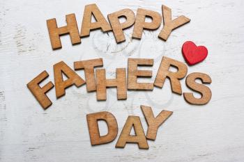 Happy Fathers Day with wooden letters on an old white wooden background