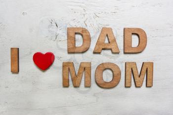 I love dad ,mom with wooden letters on an old white wooden background