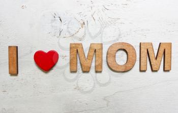 I love mom with wooden letters on an old white wooden background