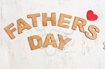 Fathers Day with wooden letters on an old white wooden background