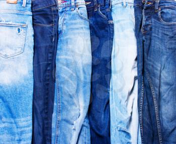 Jeans blue in a row on a white background. texture of denim