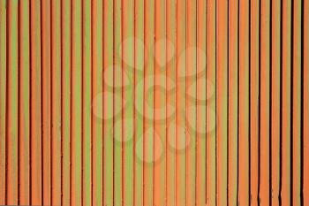 Orange rusty green background. Corrosion of metal iron. Vertical fence