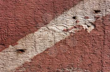 Brown wooden background with strip of red paint diagonal