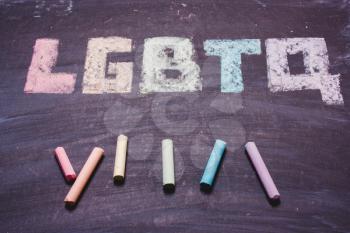 word LGBTQ  on a chalk board. LGBT symbol, rainbow colors, flag