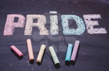 word  PRIDE on a chalk board. LGBT symbol, rainbow colors, flag