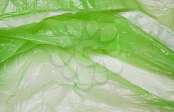 Green plastic bag. The concept of using environmentally friendly packaging, processing and sorting, preservation of the environment