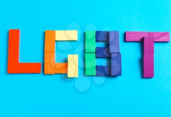 LGBT symbol made of wooden dominoes on blue background