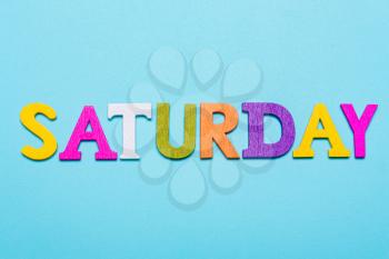 Word saturday made of colorful letters on a blue background