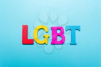 LGBT word from rainbow color letters on a blue background
