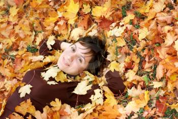 Girl in autumn leafs. Emotional scene.