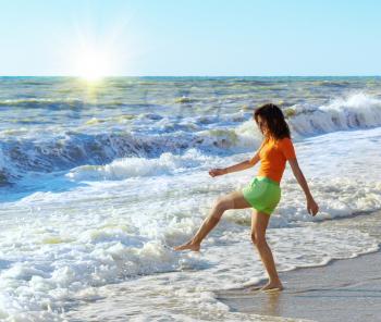 Girl play on the beach. Emotional scene.