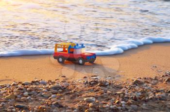 Toy on sea shore. Nature conceptual compositon.