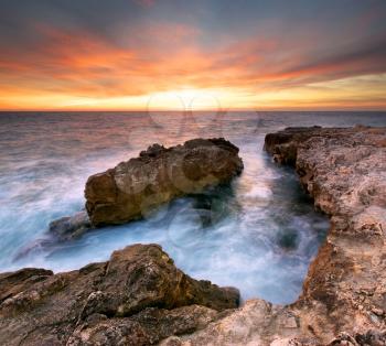 Beautiful seascape. Sea and rock at the sunset. Nature composition.