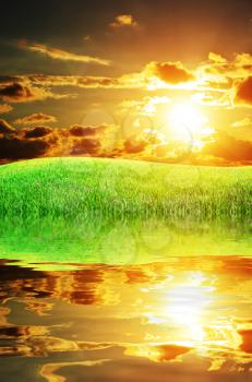 Sunset and big green meadow. Nature composition.