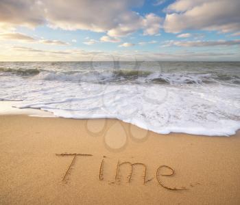 Time word on the sea sand. Conceptual nature design.