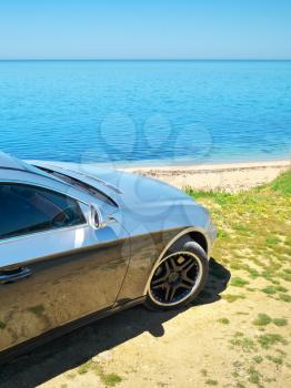 Car on the sea shore. Travel design.