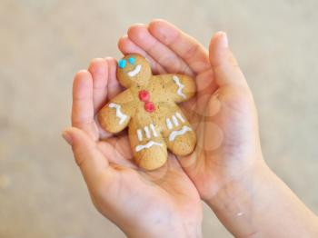 Gingerbread cookies man in child hands
