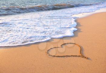 Heart on beach. Romantic composition.