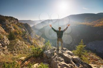 Man standing on the cliff. Conceptual scene. Mountain nature composition. 