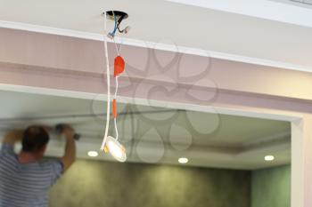 Repair of ceiling lamp. Working scene. 