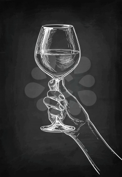 Hand holding a glass of wine. Chalk sketch on blackboard background. Hand drawn vector illustration. Retro style.