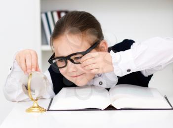 Cute girl is reading book - school, education concept