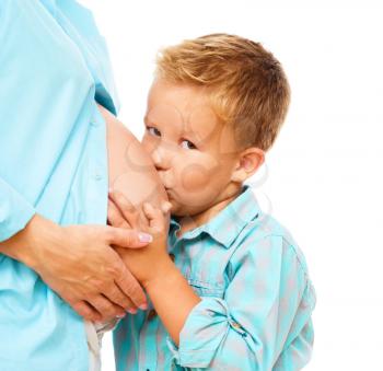 Happy child holding belly of pregnant woman, isolated over white