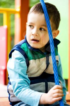 Cute little boy is playing on playground