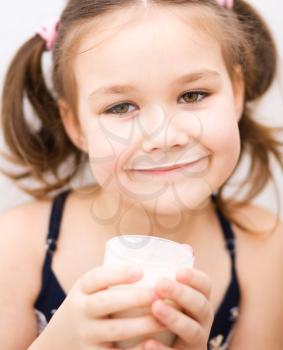 Cute little girl with a glass of milk