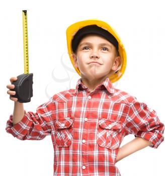 Happy cute boy as a construction worker with tape measure, isolated over white