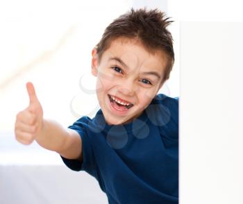 Little boy is holding blank banner