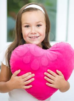 Happiness, health and love concept - smiling girl with pink heart