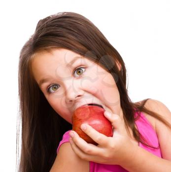 Portrait of a cute cheerful little girl with red apple, isolated over white