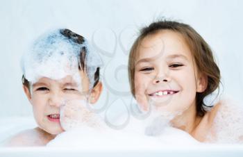 Cute children bathes in a bathroom