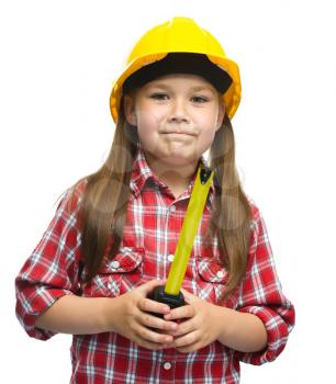 Happy cute girl as a construction worker with tape measure, isolated over white
