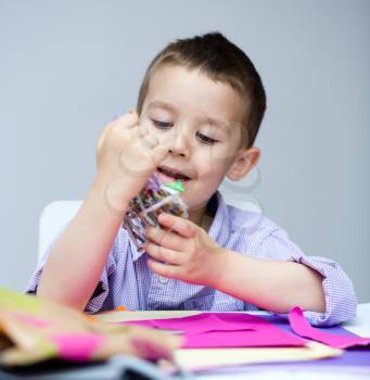 Little smiling Boy holding present box