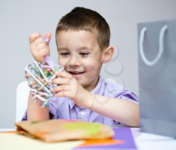 Little smiling Boy holding present box