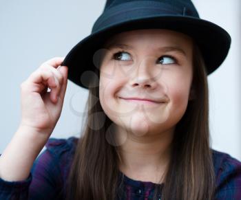 Portrait of a beautiful girl in a black hat