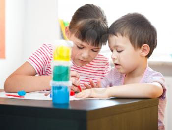 Happy children playing with color play dough