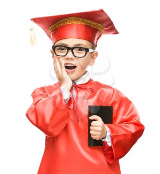 Cute boy is holding book - education concept, isolated over white