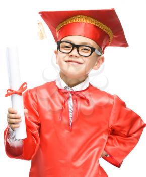 Cute boy is holding book - education concept, isolated over white