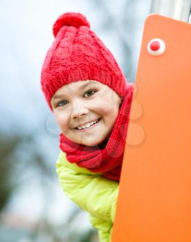 Cute happy girl is playing on playground, outdoor